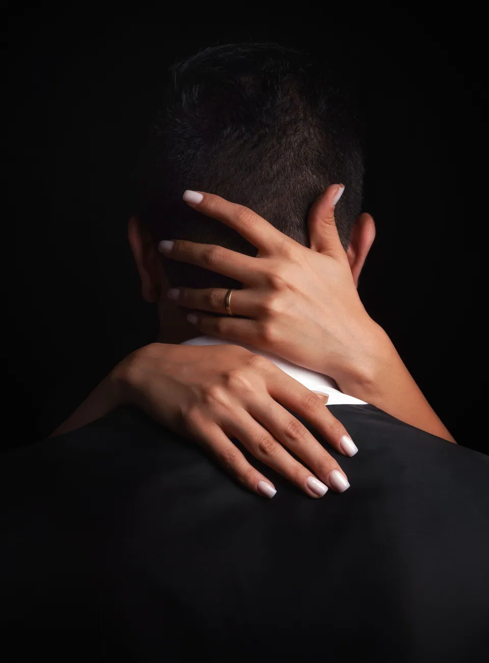 A quiet embrace, with faces kept out of view