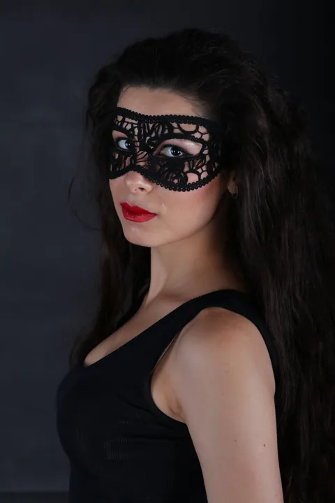A portrait of a woman wearing a masquerade mask