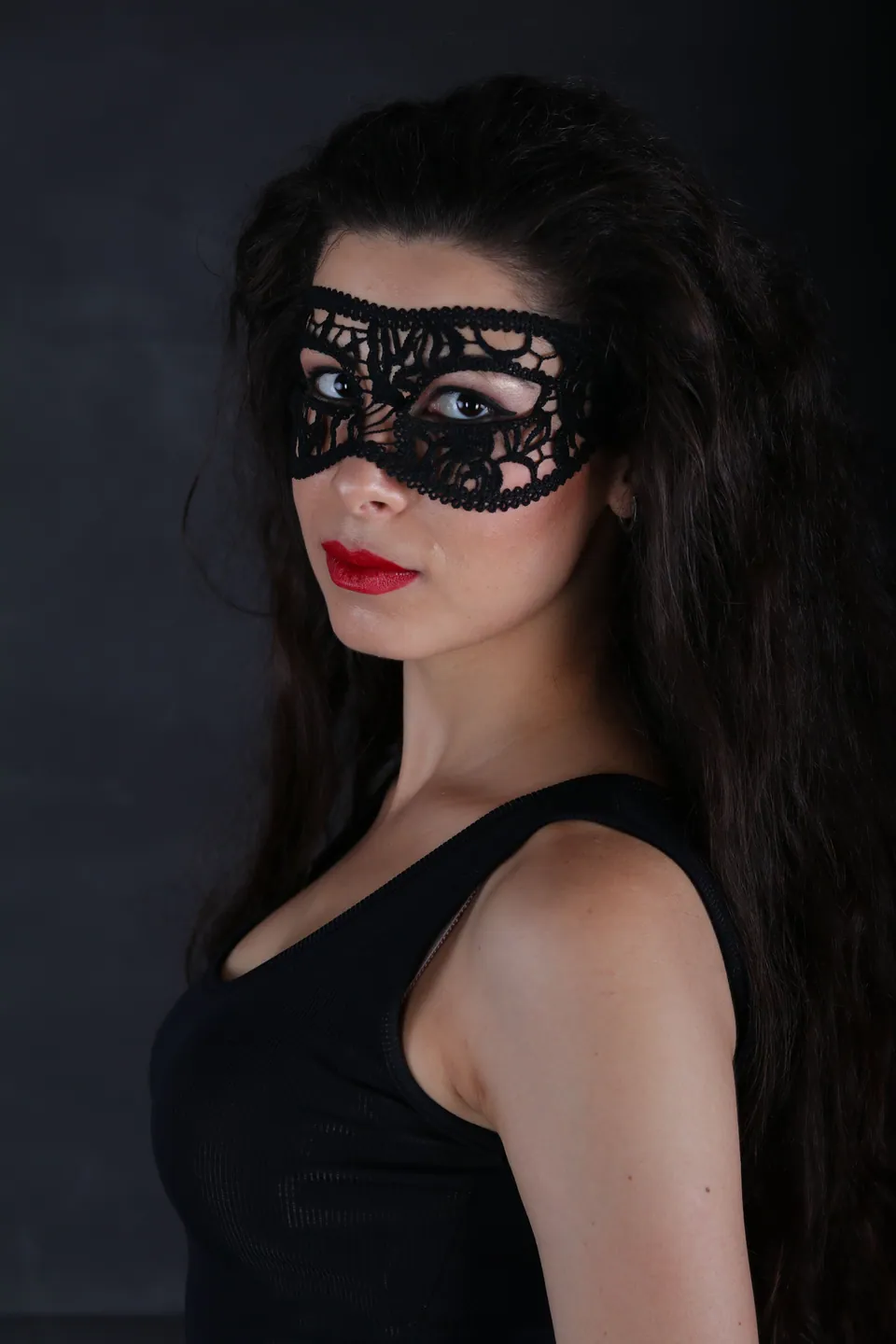 A portrait of a woman wearing a masquerade mask